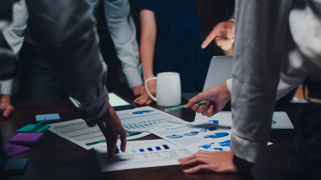 millennial asia businessmen businesswomen meeting brainstorming ideas about new paperwork project colleagues working together planning success strategy enjoy teamwork small modern night office