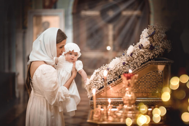 mother with small child temple church prays near icon candles came divine service russian orthodox church baptism baby