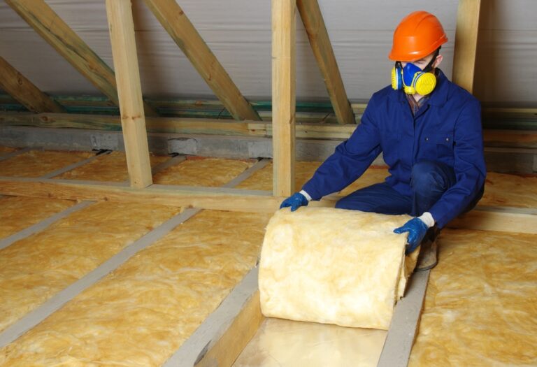 man,installing,thermal,roof,insulation,layer,using,mineral,wool.